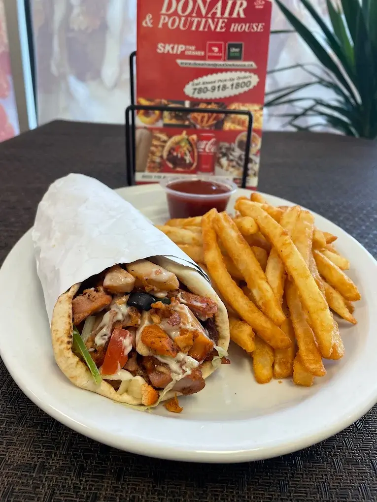 Chicken donair wrap with seasoned fries, a signature dish at Donair and Poutine House in Edmonton, AB