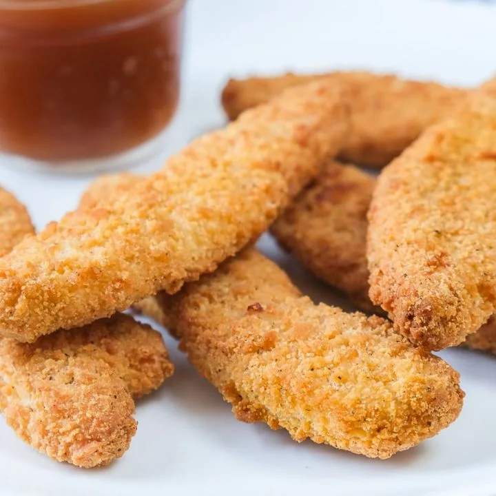Golden hand-breaded chicken fingers with dipping sauce at Donair and Poutine House in Edmonton, AB