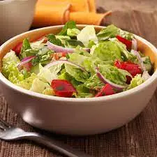 Fresh garden salad with crisp lettuce, tomato and onion at Donair and Poutine House in Edmonton, AB