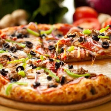 Oven-baked halal pizza with mozzarella, peppers and olives at Donair and Poutine House in Edmonton, AB